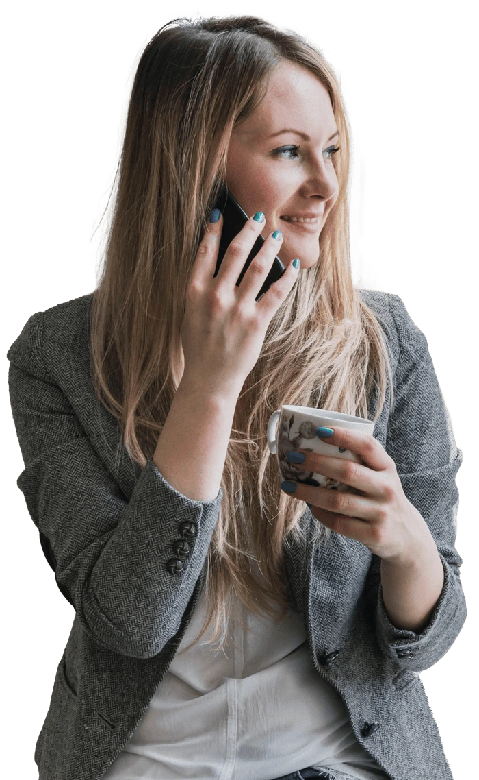 A woman on the phone and a smile on her face.